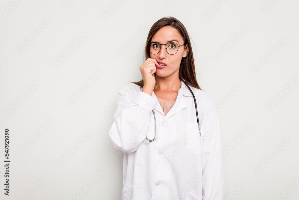 Young doctor woman isolated on white background biting fingernails, nervous and very anxious. Young doctor woman isolated on white background biting fingernails, nervous and very anxious.