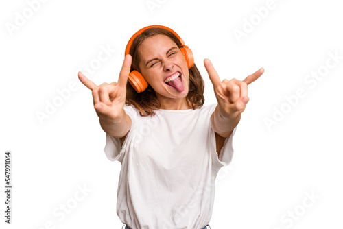 Young caucasian woman listening to music with headphones isolated
