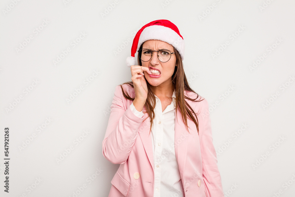 Business caucasian woman wearing a christmas hat isolated on white background biting fingernails, nervous and very anxious. Business caucasian woman wearing a christmas hat isolated on white background biting fingernails, nervous and very anxious.