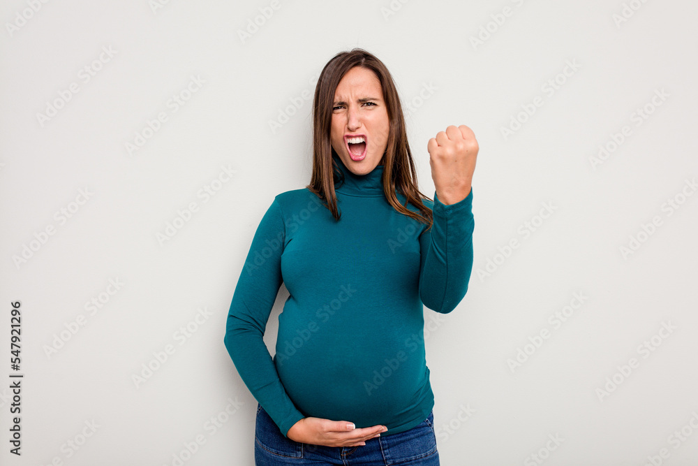 © Asier - Pregnant caucasian woman isolated on white background showing fist to camera, aggressive facial expression.