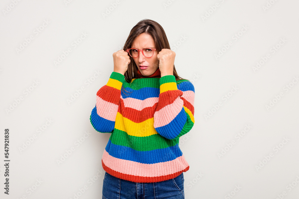 Young caucasian cute woman isolated on white background throwing a punch, anger, fighting due to an argument, boxing. Young caucasian cute woman isolated on white background throwing a punch, anger, fighting due to an argument, boxing.