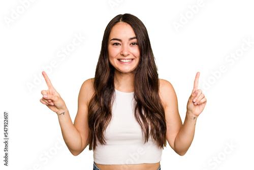 Bild auf Leinwand Young caucasian woman isolated on green chroma background indicates with both fore fingers up showing a blank space