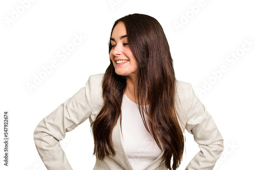 Young caucasian woman isolated on green chroma background laughs happily and has fun keeping hands on stomach.