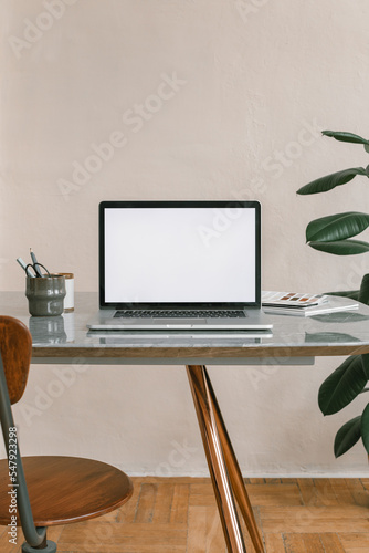 Office workplace. Blank laptop screen mockup on the table. Modern workplace. Minimal style. Copy space.