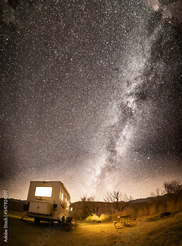 RV camped under milky way starry night sky