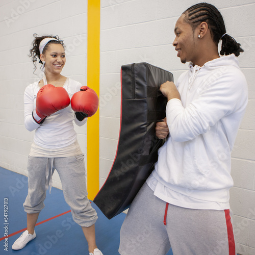 Sports Students: Kickboxing. Teenage friends learning martial arts skills and the art of self-defence. From a series of related images. photo