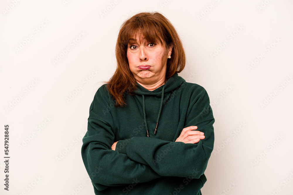 Middle age caucasian woman isolated on white background blows cheeks, has tired expression. Facial expression concept. Middle age caucasian woman isolated on white background blows cheeks, has tired expression. Facial expression concept.