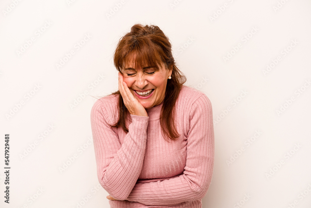 Middle age caucasian woman isolated on white background laughs happily and has fun keeping hands on stomach. Middle age caucasian woman isolated on white background laughs happily and has fun keeping hands on stomach.