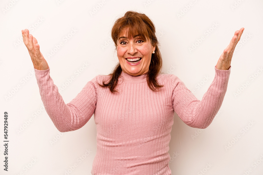 Middle age caucasian woman isolated on white background celebrating a victory or success, he is surprised and shocked. Middle age caucasian woman isolated on white background celebrating a victory or success, he is surprised and shocked.