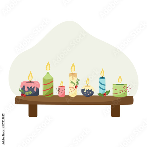 Set of Christmas candles. candles on a shelf, decorated for Christmas, a fire is burning, different shapes and sizes