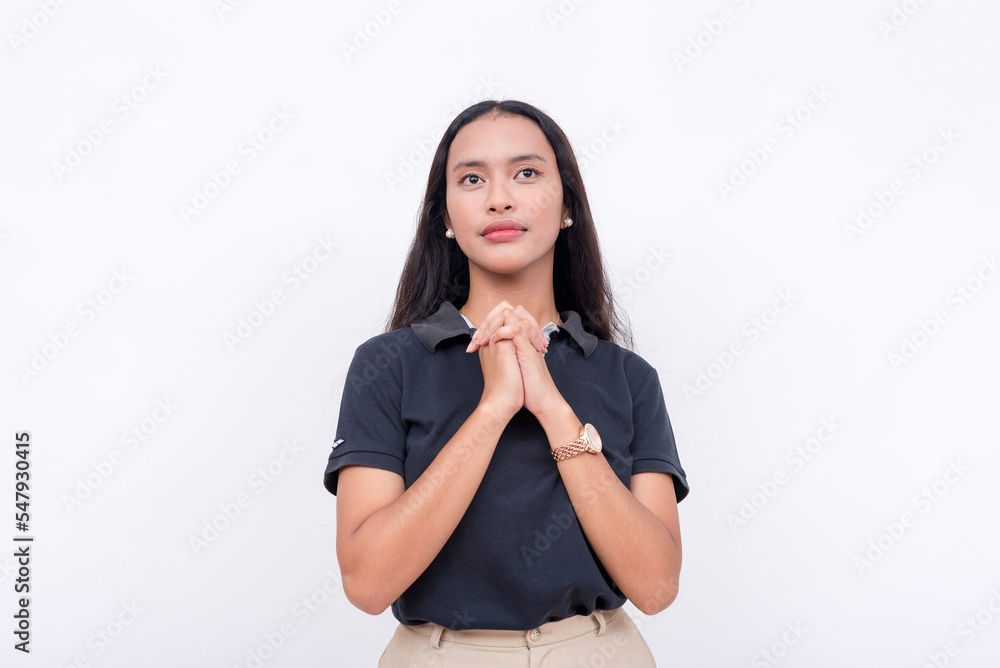 A devout young woman praying internally while looking up. A pious lady on a white background. A devout young woman praying internally while looking up. A pious lady on a white background.