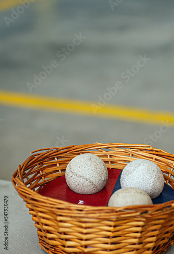 detail of some fronton balls inside a wicker basket. basque pelota. vertical format. concept sports in basque country. spain. photo