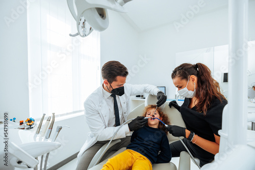 Dentist and assistant working together on small patient.
