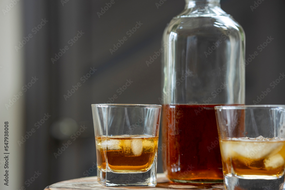 Close-up of a glass of whiskey with ice cubes Close-up of a glass of whiskey with ice cubes