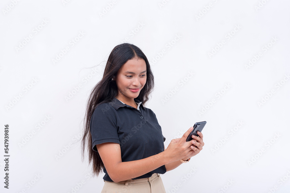 A young woman browsing her social media feed on her cellphone. A modern lady employee. Communication and app concept. Isolated on a white backdrop. A young woman browsing her social media feed on her cellphone. A modern lady employee. Communication and app concept. Isolated on a white backdrop.