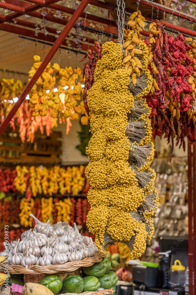 colorful spices, Achillea Filipendulina flowers and garlic at covered market, Funchal, Madeira