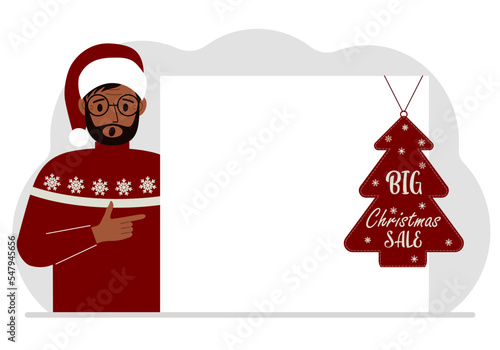 A man near a large white sheet of paper with a big sale label on it. New Year and Christmas sales.