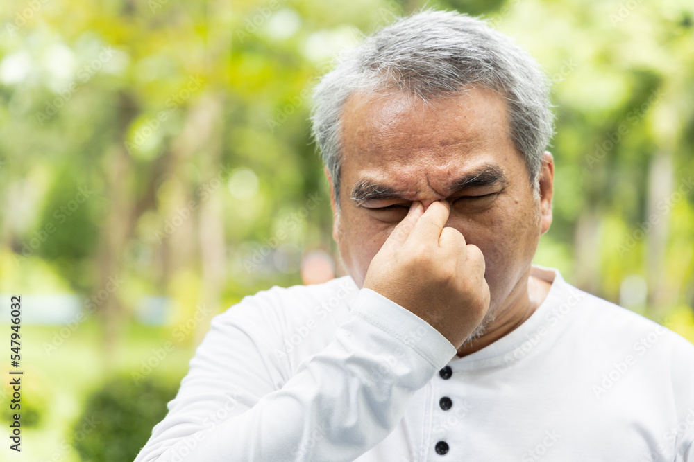 Old asian senior man suffering from headache, health and sickness concept image for vertigo symptoms, dizziness, stroke, Alzheimer, brain cancer