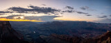 Desert landscape of the famous Grand Canyon at dusk, there are clouds and the orange sky
