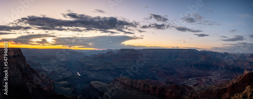 Desert landscape of the famous Grand Canyon at dusk, there are clouds and the orange sky © Adolf