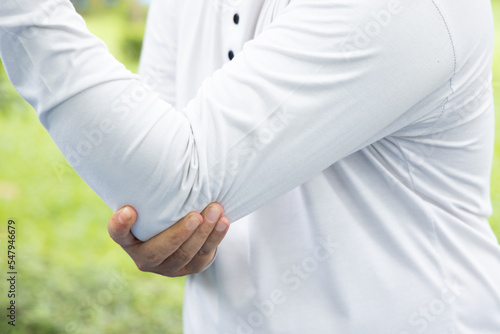 Photography sick old senior man suffering from elbow joint pain; concept of tennis elbow or