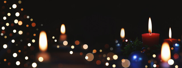 Sparkling church Christmas tree decorations, brightly lit candles and light background celebrating the Christmas of Jesus Christ
