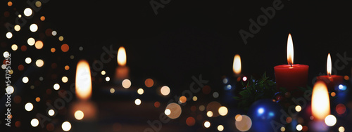 Sparkling church Christmas tree decorations, brightly lit candles and light background celebrating the Christmas of Jesus Christ 