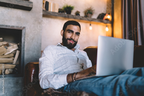 Smiling businessman using netbook for work