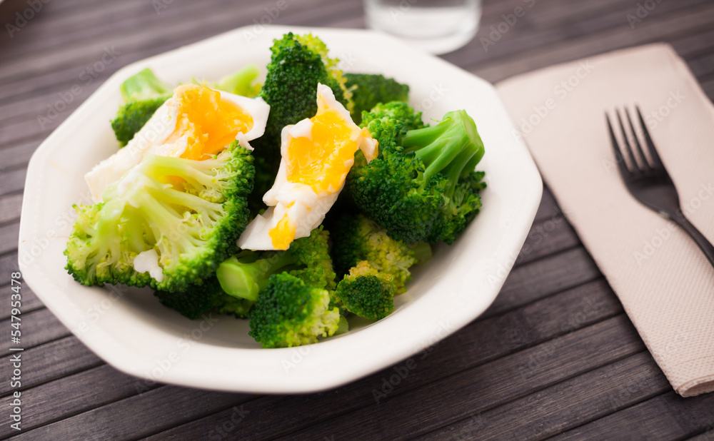 healthy food. steamed broccoli inflorescences with boiled egg in a bowl healthy food. steamed broccoli inflorescences with boiled egg in a bowl