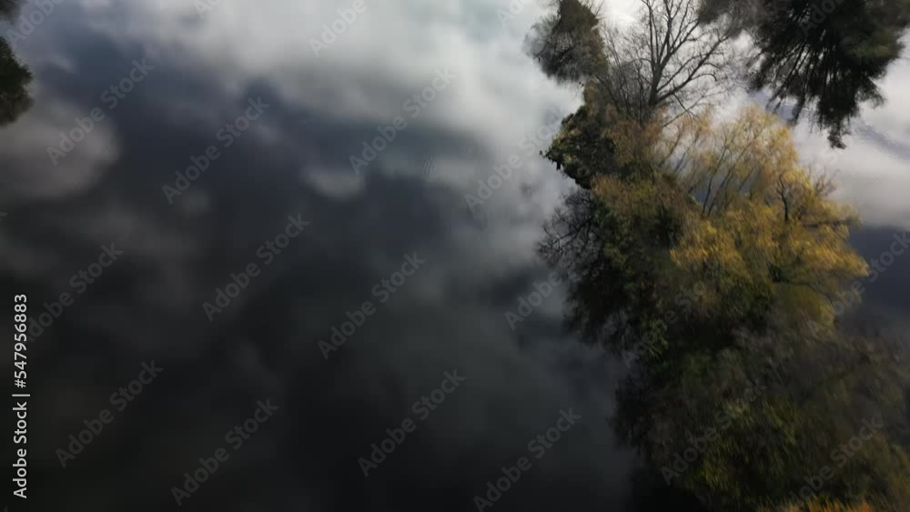Little islands of trees in the middle of the river. The sky reflects off the surface. Beautiful cinematic shot. Little islands of trees in the middle of the river. The sky reflects off the surface. Beautiful cinematic shot.