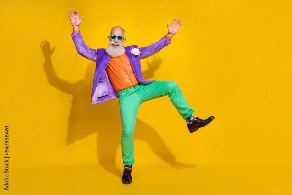 Full length photo of cool impressed guy dressed violet velvet jacket rising hands dancing disco empty space isolated yellow color background