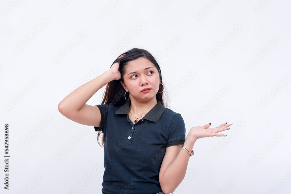 A young annoyed and condescending asian woman shrugs while looking to the right, claiming not to know what to do. Isolated on a white background. A young annoyed and condescending asian woman shrugs while looking to the right, claiming not to know what to do. Isolated on a white background.