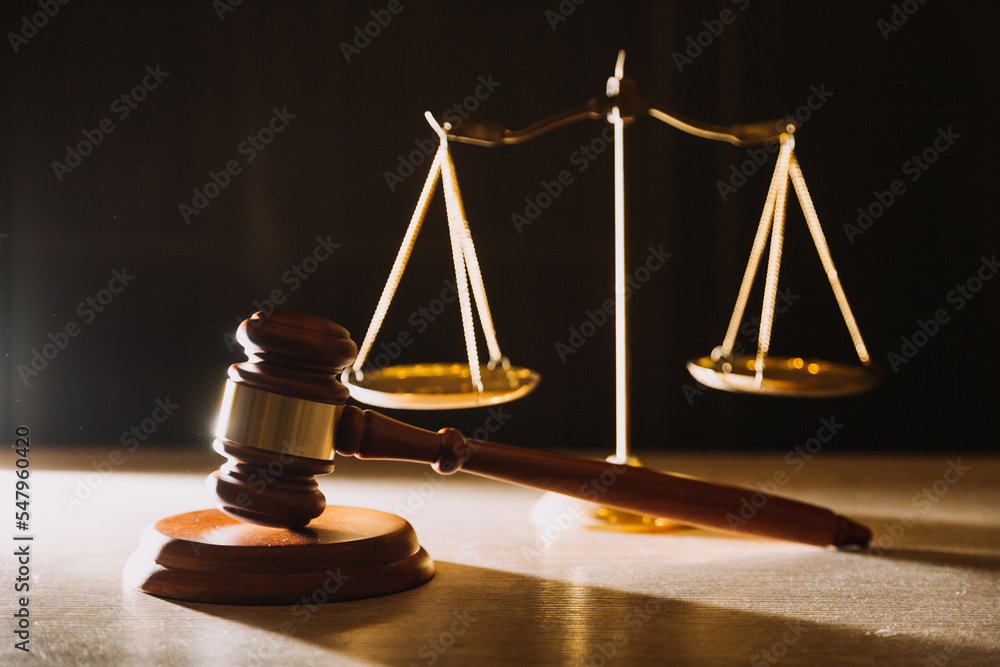 law books and scales of justice on desk in library of law firm. jurisprudence legal education concept. law books and scales of justice on desk in library of law firm. jurisprudence legal education concept.