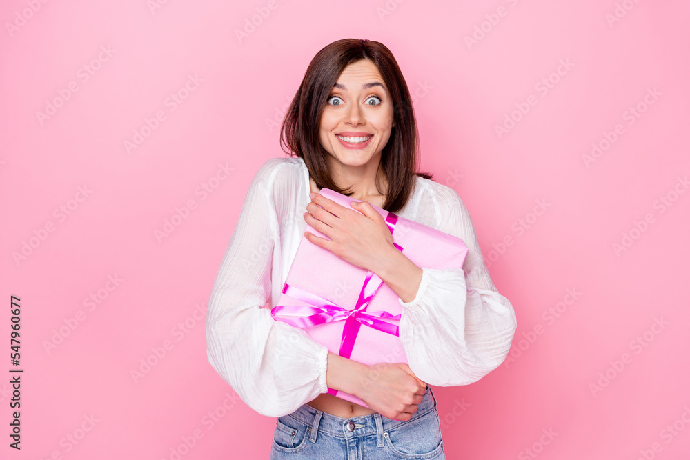 Photo of overjoyed impressed lady dressed stylish clothes hand hold hug gift box isolated on pink color background Photo of overjoyed impressed lady dressed stylish clothes hand hold hug gift box isolated on pink color background