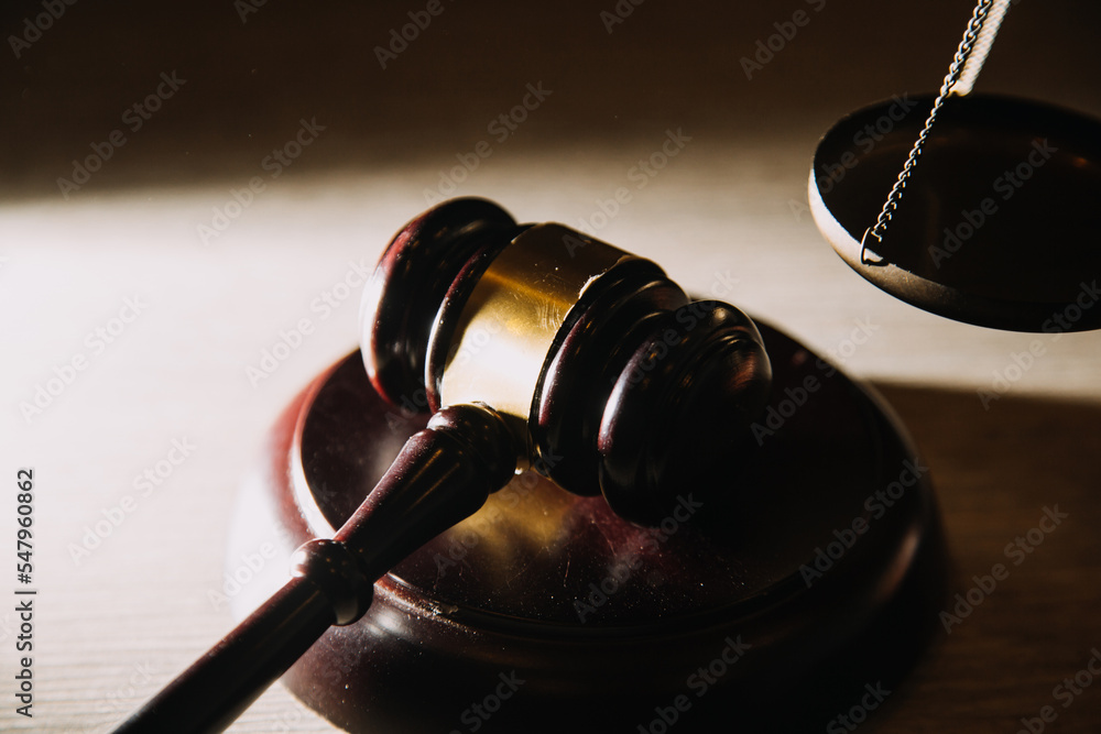 law books and scales of justice on desk in library of law firm. jurisprudence legal education concept. law books and scales of justice on desk in library of law firm. jurisprudence legal education concept.
