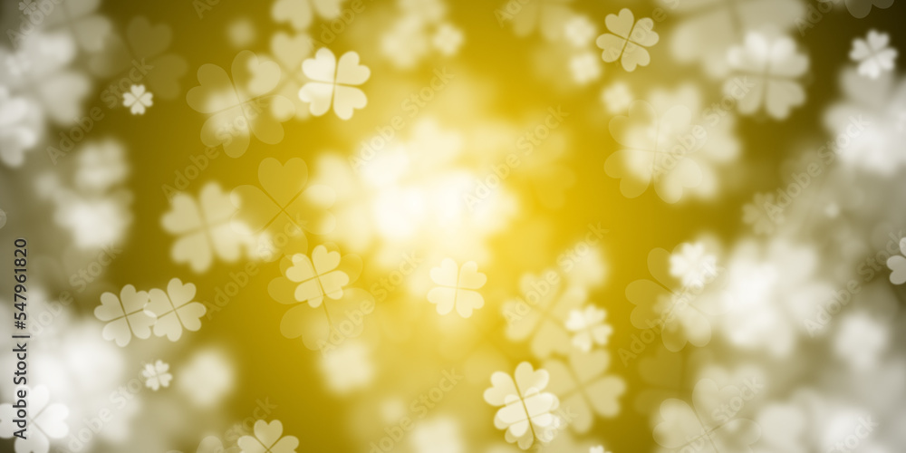 Abstract yellow background with flying four leaf clovers