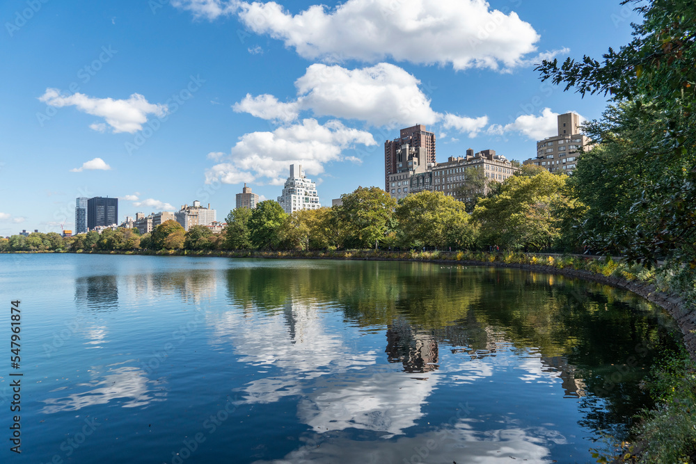 Corner view of Central Park, city center park, sky reflected on lake in park in Isle of Manhunt, New York