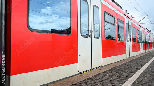 Passenger train speeding through station. Rail transport. Modern train in Germany.