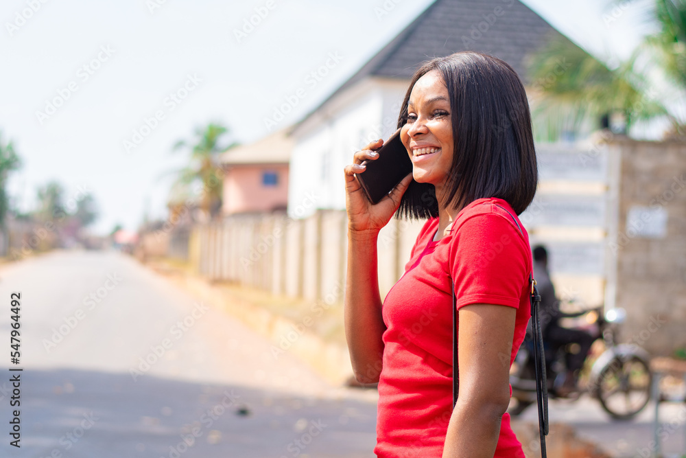 pretty african lady making a phone call smiling