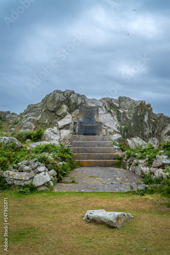 Stone throne with dramatic cloudy sky on the top of Saltee Island, Ireland.