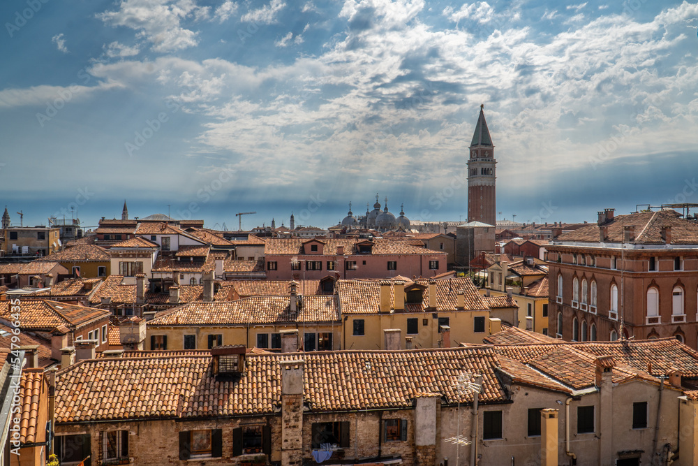 Rooftops and st. Marks Campanile in venice with rays of the sun. 