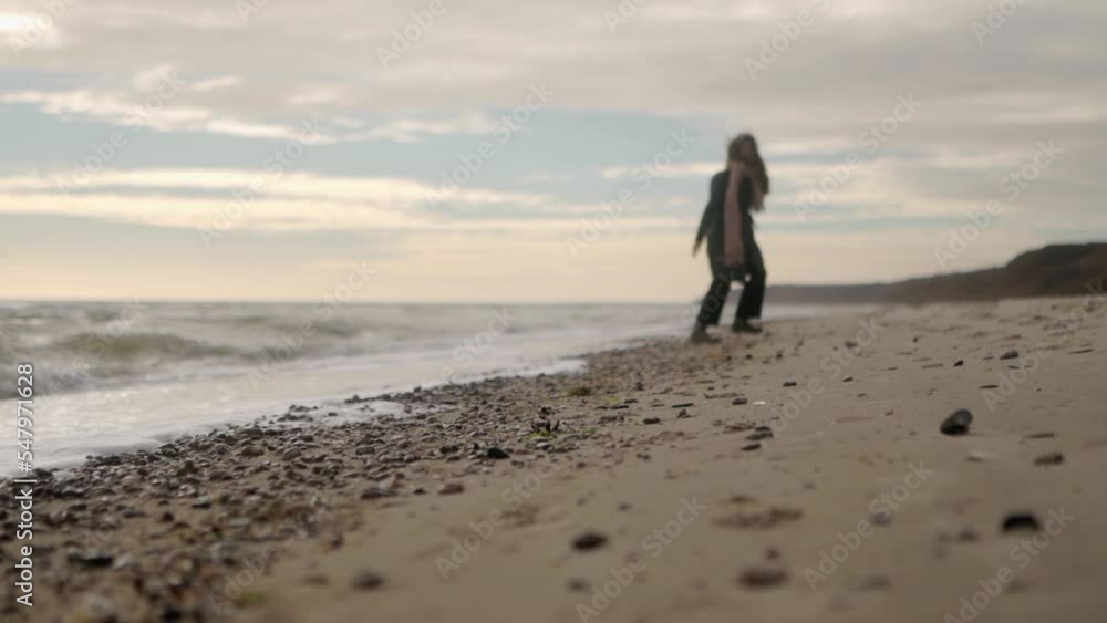 Happy mixed ethnic woman running away on sandy sea beach to background bokeh. Playful smiling asian female airy hair blowing in wind. Low angle wide dreamy cinematic slow motion 120 fps. Happy mixed ethnic woman running away on sandy sea beach to background bokeh. Playful smiling asian female airy hair blowing in wind. Low angle wide dreamy cinematic slow motion 120 fps.