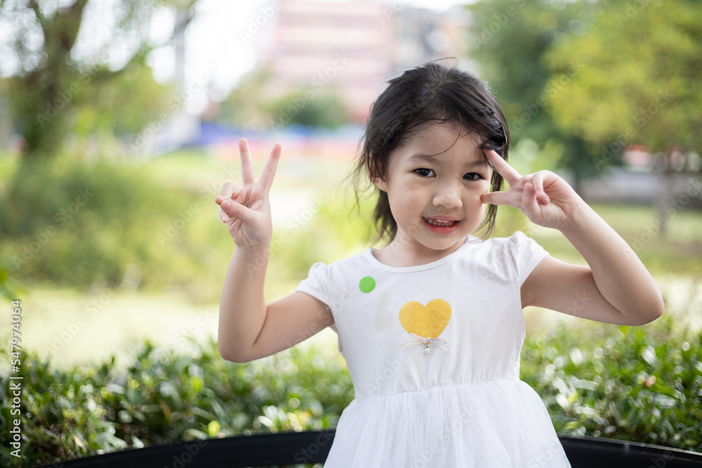 Sweet, happy, smiling three year old girl playing in a park outdoor. Sweet, happy, smiling three year old girl playing in a park outdoor.