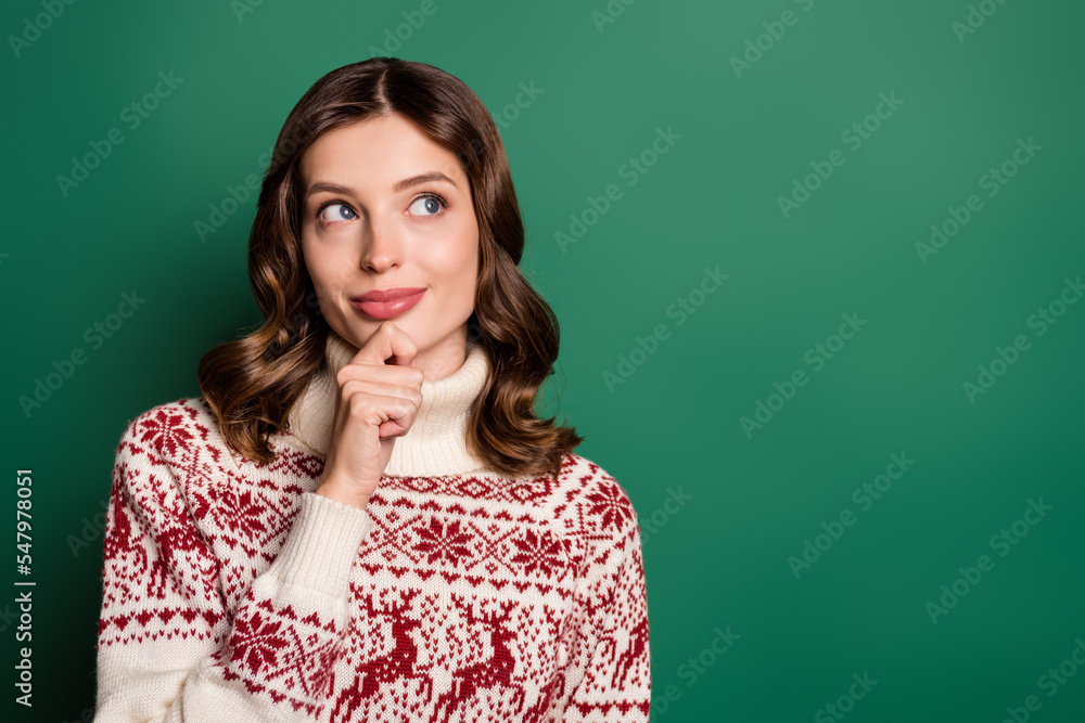 Portrait of adorable minded creative lady hand touch chin look empty space isolated on green color background Portrait of adorable minded creative lady hand touch chin look empty space isolated on green color background
