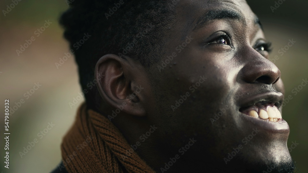 Hopeful black African man close-up face joyful emotion Hopeful black African man close-up face joyful emotion