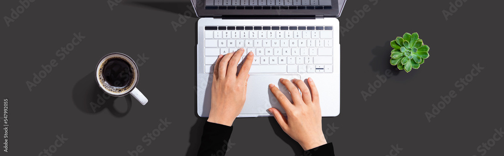 Person using a laptop computer from above Person using a laptop computer from above
