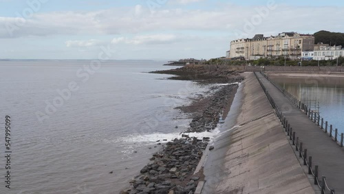 Wallpaper Mural Water being released from the artificial beach in Weston-super-Mare into the sea, waves crushing into the rocky beach. Some buildings in the background. Camera still. 4K Torontodigital.ca
