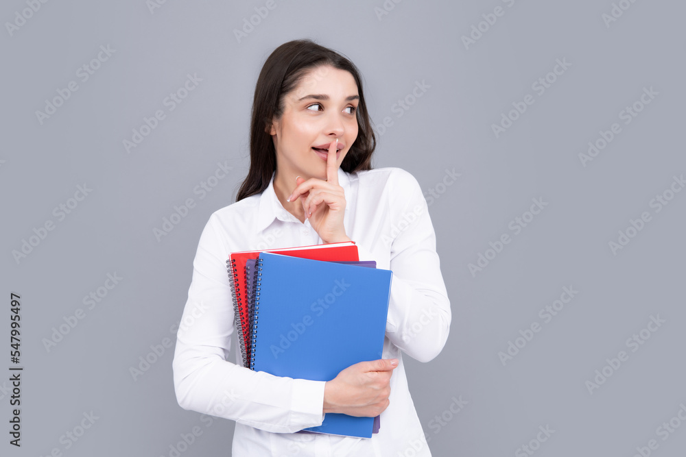 Charming student isolated on gray background. Woman high school student hold notebooks. Education in high school university college. Charming student isolated on gray background. Woman high school student hold notebooks. Education in high school university college.