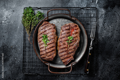 Grilled Top Blade or flat iron beef meat steaks. Black background. Top View