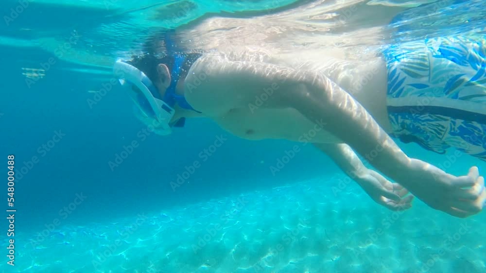 Underwater view of a fit young man snorkeling with blue swimsuit in Mallorca. Underwater view of a fit young man snorkeling with blue swimsuit in Mallorca.